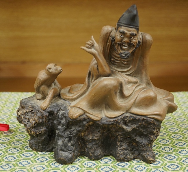 A Chinese Shiwan figure group of a luohan and monkey, housed in a fitted box, 21cm wide. Condition - good